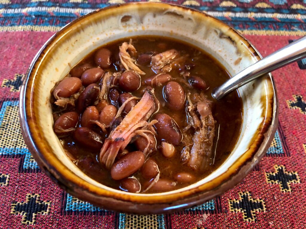 pinto beans with pulled pork in a bowl