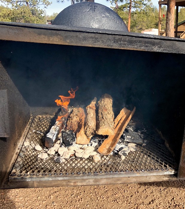 firewood burning in a BBQ smoker